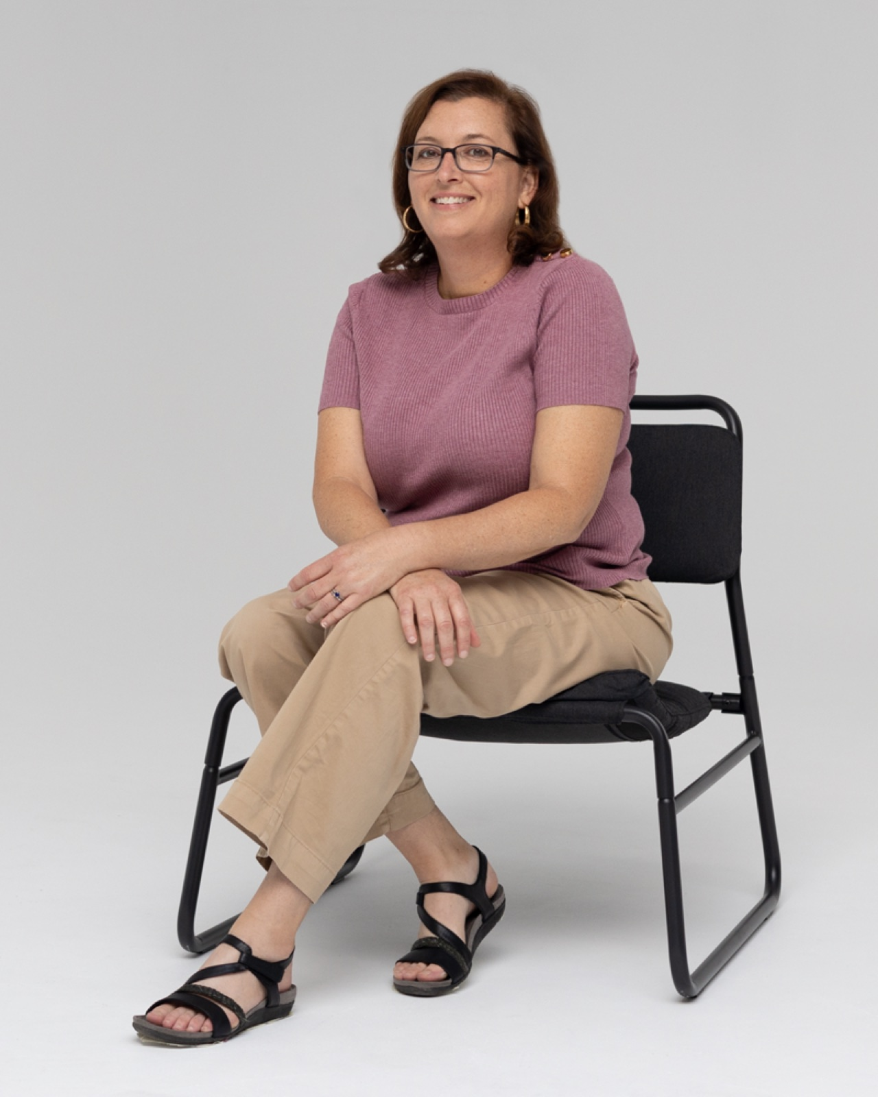 Amy Ross, Certified Hypnotherapist, seated and smiling